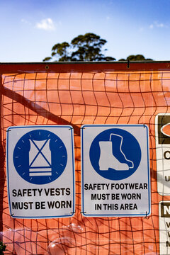 Safety signage on a barrier fence at a construction site