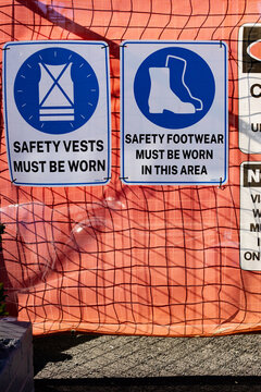 Safety signage on a barrier fence at a construction site
