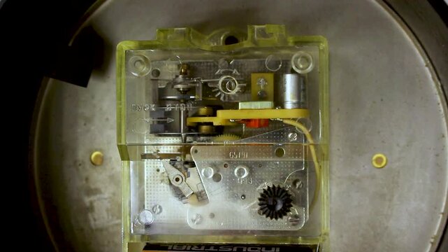 Transparent mechanical clockwork mechanism with gears and internal components inside industrial device casing