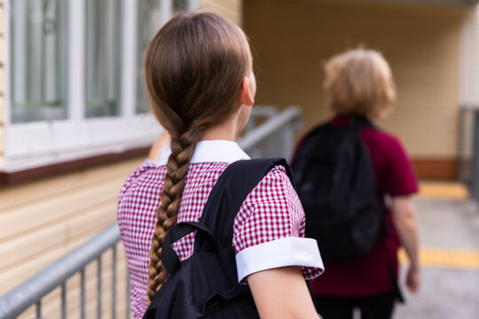 school kids lining up outside an old building