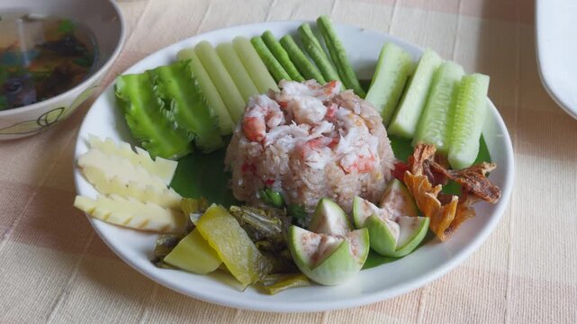 Authentic Thai Shrimp Paste Fried Rice with Fresh Vegetables and Crispy Fish on Plate &ndash; Close-up Top Down View Food Cinematic Shot