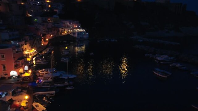 Drone panorama of Procida town lights and marina during