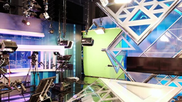 Modern television studio interior with professional cameras and lighting equipment for live news broadcast production.