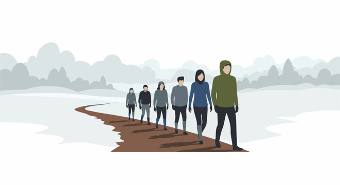 Group of people walk on a snowy path during winter with a foggy background