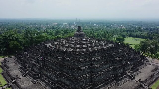 Aerial View of Borobudur Temple in Indonesia Surrounded by Lush Greenery.