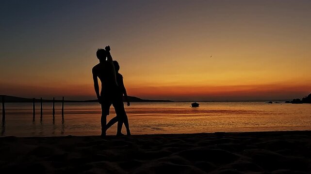 Playful silhouette couple spinning and dancing on sunset beach