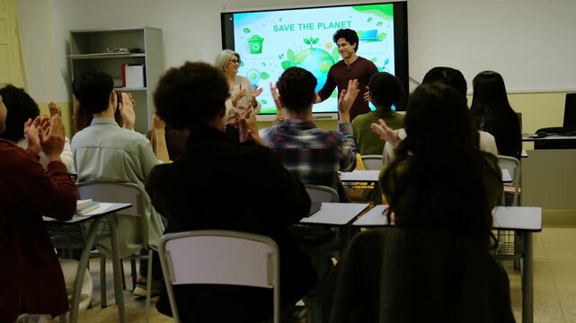 Students and a teacher clapping hands after a classmate's speech about saving the planet
