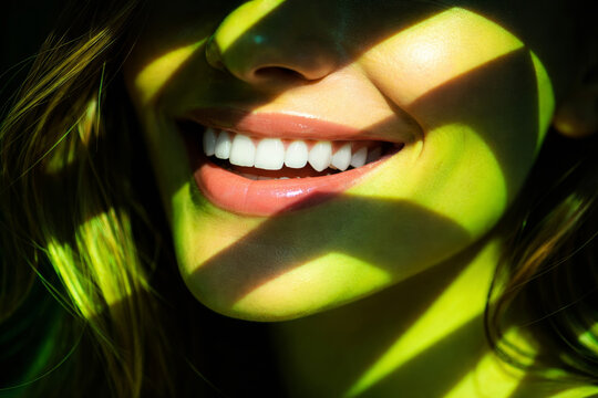 Close-up of a smiling woman with beautiful white teeth and natural light