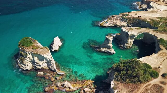 Aerial view of Faraglioni di Sant'Andrea sea stacks in Puglia, Puglia, Italy