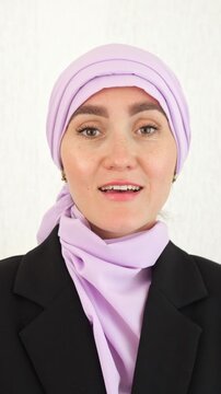 Serious Woman In Purple Hijab. Woman Wearing Purple Hijab Shows Authority Confidence. An Authoritative Woman In Purple Hijab Projects Confidence And Professionalism In Her Portrait