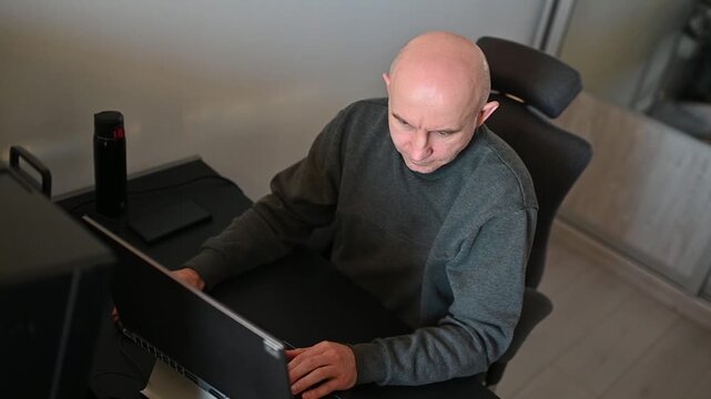 Overhead view of focused businessman working at computer in home office, Full HD video