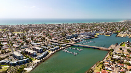 Obraz premium Port Adelaide, South Australia: 4K aerial drone view of harbour, Port River, marina, coastal suburbs and historic waterfront cityscape, presidential houses, estates in Ethelton, Semaphore Park