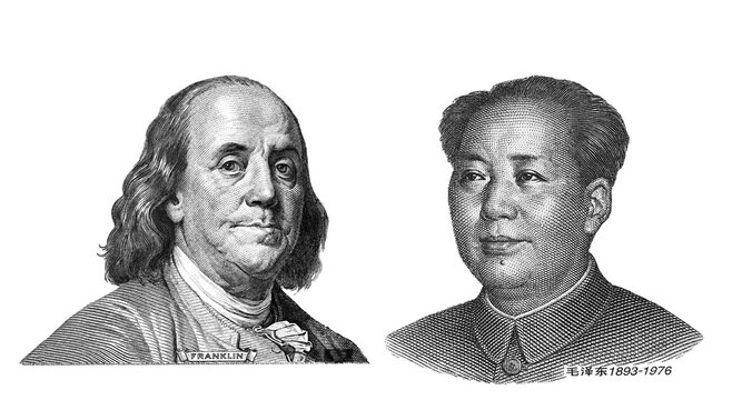 Engraved portraits of Benjamin Franklin from US dollar and Mao Zedong from Chinese yuan isolated on background