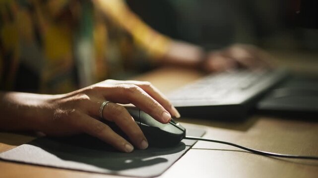 Close-Up of Hand Clicking Computer Mouse at Workplace

Alternative Titles: