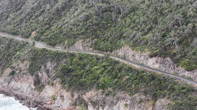 Bus on B100 Great Ocean road highway in Victoria scenic drive tourism destination.
