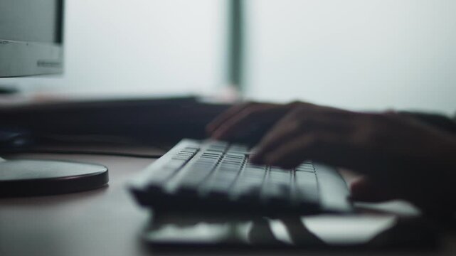 Close-Up of Hands Typing on Keyboard in Office
