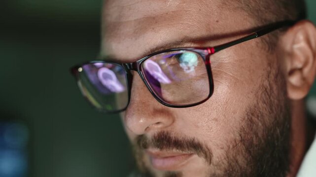 Close-up of serious doctor wearing glasses while analyzing medical data, reflecting radiology expertise, diagnosis and professional healthcare work.