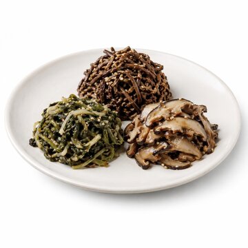 Jinchae or boreum namul three neat mounds of korean seasoned dried vegetables on a matte white ceramic plate dried bracken fern dried radish greens and shiitake mushrooms glossy sesame oil finish
