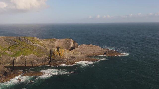 The rugged cliffs stand against the vast expanse of the ocean, enduring the waves and wind. The deep, restless sea mirrors the sky. A place where the land meets the sea.