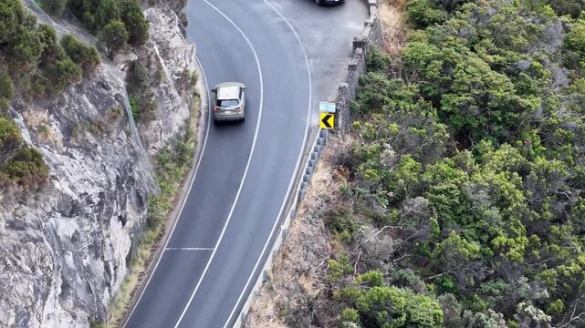 Lookout on Great Ocean road B100 highway traffic on waterfront edge of eroded coast.