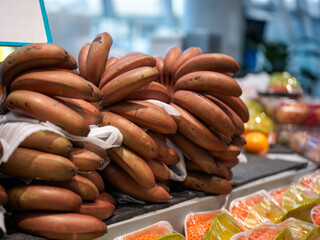 Stack of Red Bananas at Market Stall © Dong