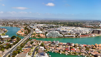 Obraz premium West Lakes, South Australia: 4K aerial drone view of coastal suburb, shore, canal waterways, residential housing, marina areas, bridges and urban waterfront landscape, Grange Beach, Tennyson Beach