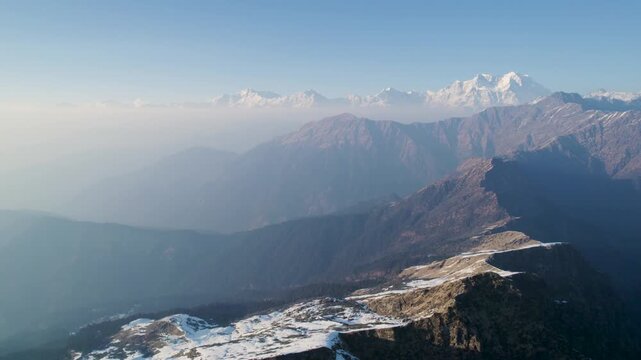 Aerial view of the Shri Tungnath Temple range with snow-capped Himalayan peaks and rugged mountain ridges Rudraprayag, Uttarakhand, India.
