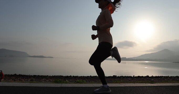 Fitness woman runner running at seaside	