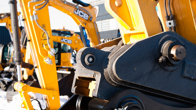 Riga, Latvia - February 8, 2026: Close-up of a black excavator bucket, yellow excavator boom with the JCB logo on the back