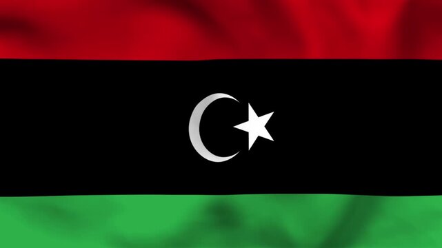 National flag of Libya on wavy cloth. Features horizontal red, black, and green bars with a white emblem. Professional top-down view for North African history and national independence day