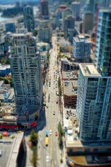Fototapeta premium Aerial View of a City Street with Tall Buildings and Traffic.