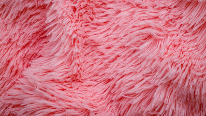 Fototapeta premium Soft pink fluffy fabric spreads across a surface in a bright space with natural light during daytime
