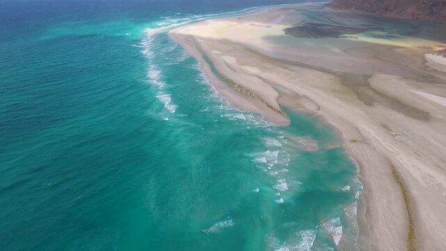 Aerial turquoise ocean and sandbar with lagoon