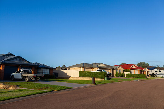 Sunlit homes along street on early autumn morning