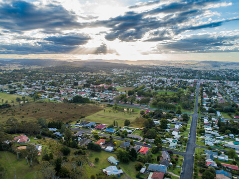 Sunrays through clouds in evening with view over town of Glen Innes in NSW Australia