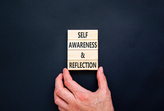 Self awareness and reflection symbol. Concept words Self awareness and reflection on beautiful wooden blocks. Beautiful black background. Psychological self awareness reflection concept. Copy space.