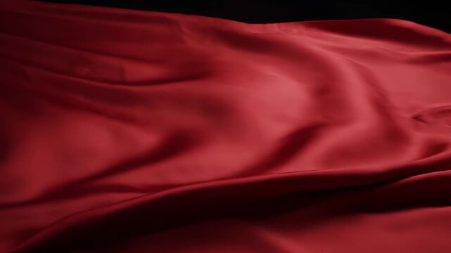 Elegant flowing red silk fabric abstract background texture.