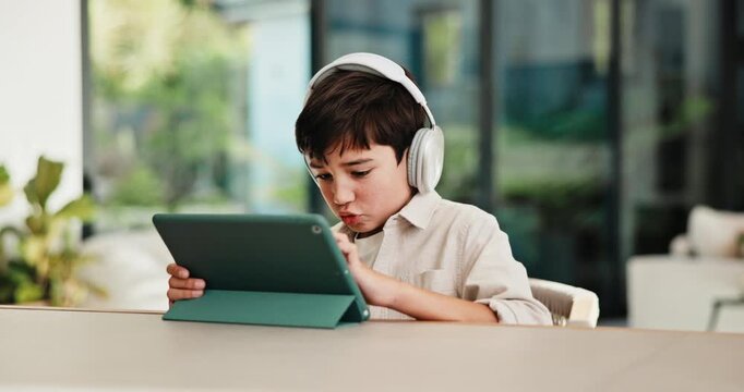 Boy, tablet and elearning with headphones in home for online interaction or engagement. Child, kid or education with technology or app for digital course, childhood development or connection in house