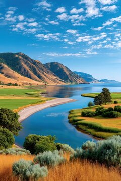 Panoramic Yellowstone National Park landscape with river, mountains, meadows and clear summer sky