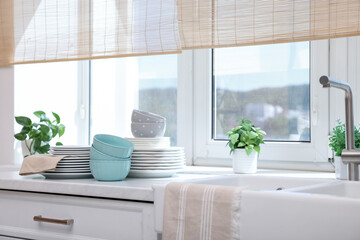 Set of clean dishes on countertop in kitchen