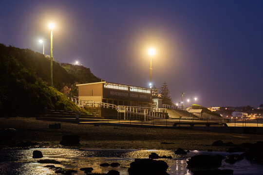 Merewether Ocean Baths building on coast at night