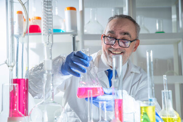 Fototapeta premium Joyful professional male scientist celebrating a successful laboratory experiment and scientific discovery, showing confidence, optimism and research achievement.