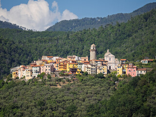 Obraz premium A glimpse of the beautiful Ligurian village of Ortonovo at the top of the hill with its typical circular tower.
