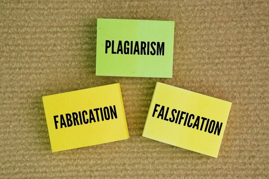 Paper with the words Plagiarism, Fabrication, Falsification. the three "cardinal sins" of scientific and academic misconduct. these actions undermine the integrity of the research process 