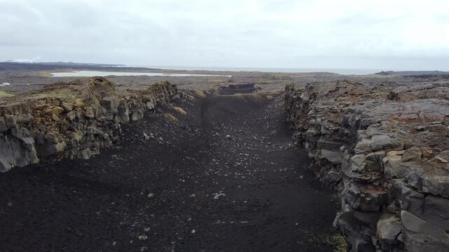 Rugged volcanic landscape showing the tectonic fissure between the North American and Eurasian plates in Iceland on an overcast day