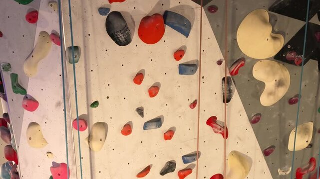 Indoor climbing wall with colorful holds full frame sport background