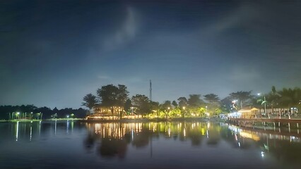 Obraz premium Beautiful Night Landscape of City Park Lake with Light Reflection