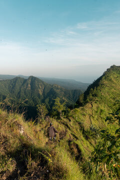 Candid Documentary Shot of Local Farmer on Bukit Mende Ridge with Ocean Backdrop