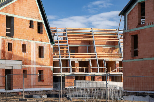 Residential apartment block under construction. Red brick shell construction site.