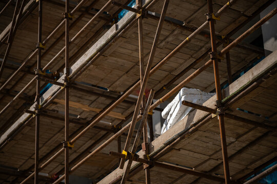 Close-up detail of metal scaffolding on a multi-story building construction site
